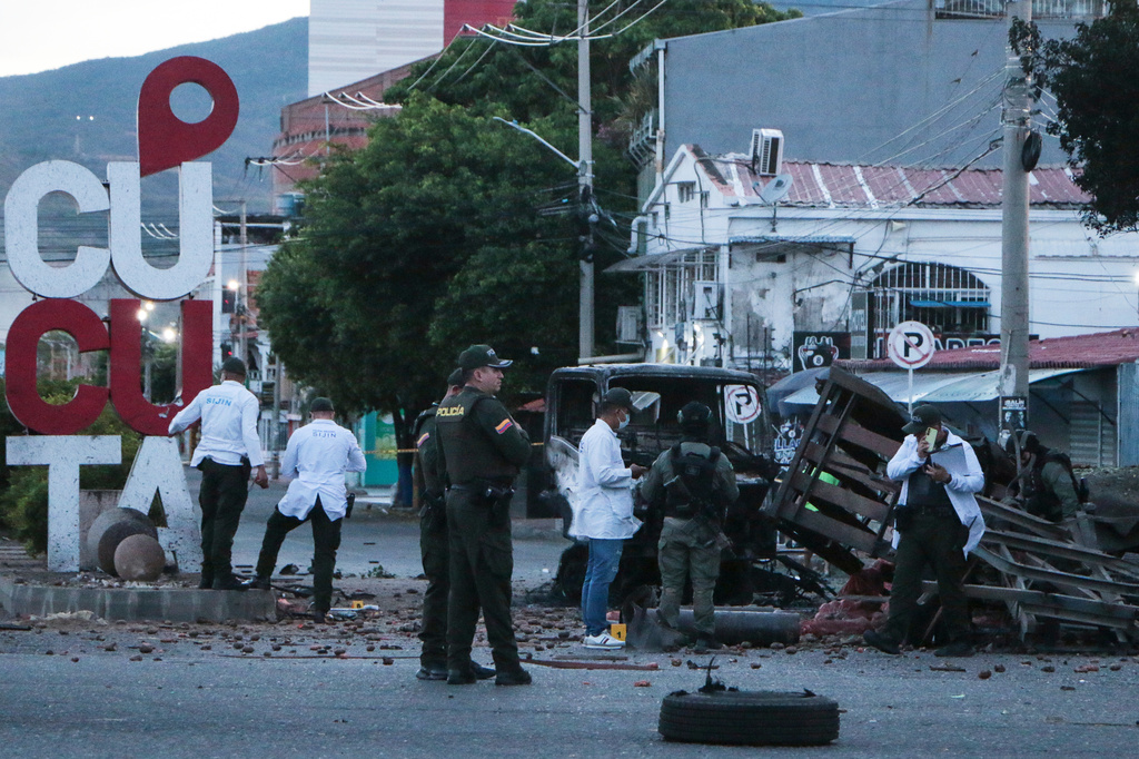Police inspect the scene after a truck exploded outside a police station in Cucuta, Colombia, Saturday, Aug. 1, 2026. (AP Photo/Mario Caicedo)