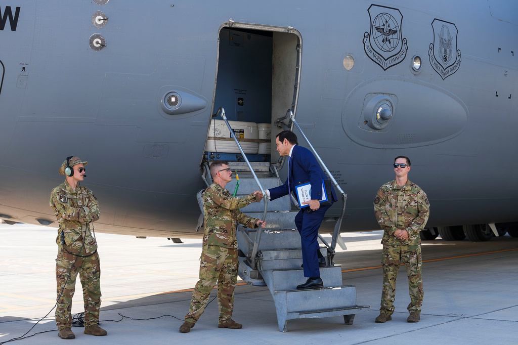 U.S. Secretary of State Marco Rubio greets crew members as he boards a U.S. Air Force C-17 Globemaster III transport aircraft at Bahrain International Airport after his visit to the Middle East, in Manama, Bahrain Thursday, June 25, 2026. (Eric Lee/Pool Photo via AP)
