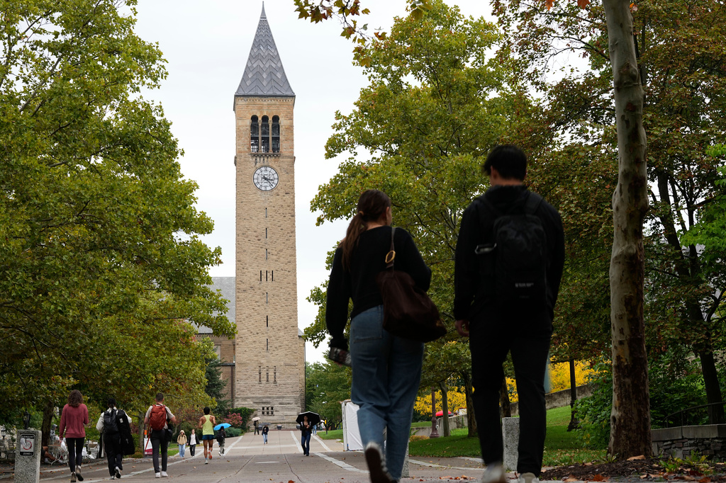 Pedestrians walk on the campus at Cornell University in Ithaca, N.Y., Thursday, Oct. 1, 2026. (AP Photo/Matt Rourke)