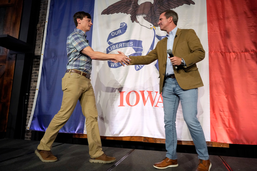 Iowa Democratic gubernatorial candidate Rob Sand, left, greets Kentucky Gov. Andy Beshear during a campaign rally, Sunday, June 7, 2026, in Des Moines, Iowa. (AP Photo/Charlie Neibergall)