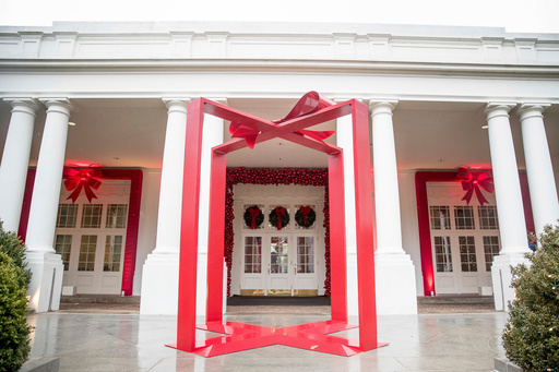 FILE - A large ribbon is displayed outside the East Wing of the White House during a preview of the 2016 holiday decor, Nov. 29, 2016, in Washington. (AP Photo/Andrew Harnik, File) FILE - A large ribbon is displayed outside the East Wing of the White House during a preview of the 2016 holiday decor, Nov. 29, 2016, in Washington. (AP Photo/Andrew Harnik, File)