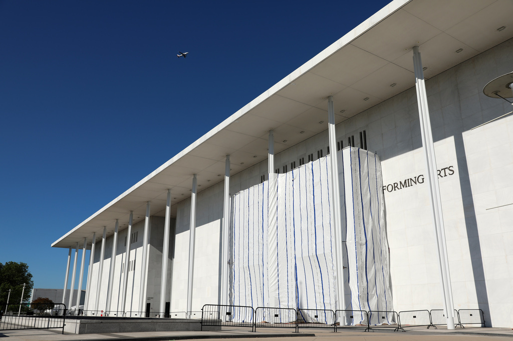 The wall of the John F. Kennedy Center for the Performing Arts is covered in tarp as work continues on the removal of President Donald Trump's name, Saturday, June 13, 2026 in Washington. (AP Photo/Rahmat Gul)