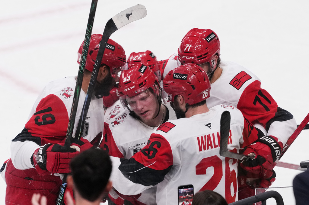 Carolina Hurricanes right wing Jackson Blake (53) is hugged by teammates after scoring during the second period in Game 6 of the NHL hockey Stanley Cup Final series against the Vegas Golden Knights, Sunday, June 14, 2026, in Las Vegas. (AP Photo/Candice Ward)
