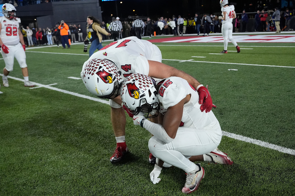 Illinois State linebacker Mason Kaplan (14) consoles defensive back Cam Wilson (25) after losing the FCS Championship NCAA college football game in overtime against Montana State, Monday, Jan. 5, 2026, in Nashville, Tenn. (AP Photo/George Walker IV)
