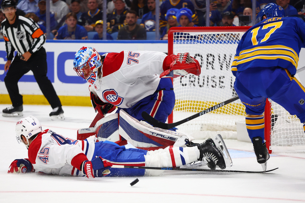 Montreal Canadiens defenseman Alexandre Carrier (45) blocks a shot by Buffalo Sabres left wing Jason Zucker (17) in front of Canadiens goaltender Jakub Dobes (75) during the first period in Game 7 of a second-round NHL hockey Stanley Cup playoff series Monday, May 18, 2026, in Buffalo, N.Y. (AP Photo/Jeffrey T. Barnes)