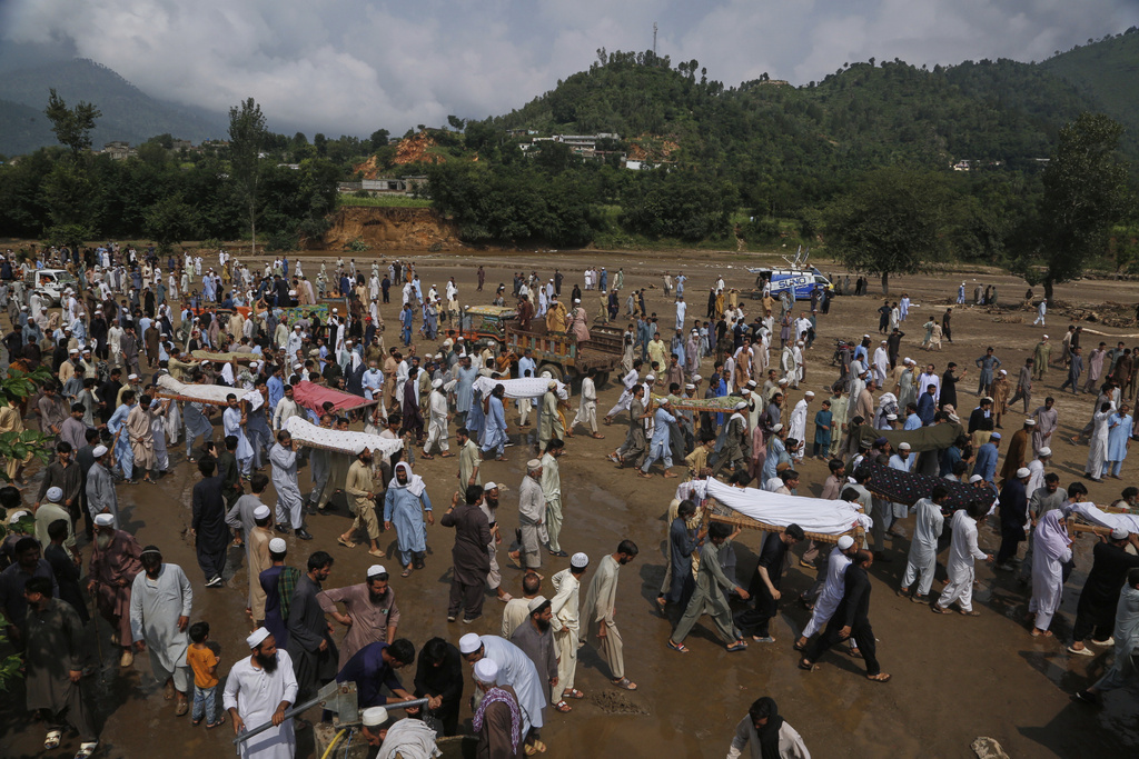 People carry bodies of the victims of Friday's flash flooding, after funeral prayers at a village near Pir Baba, Buner district, in Pakistan's northwest, Saturday, Aug. 16, 2025. (AP Photo/Muhammad Sajjad)