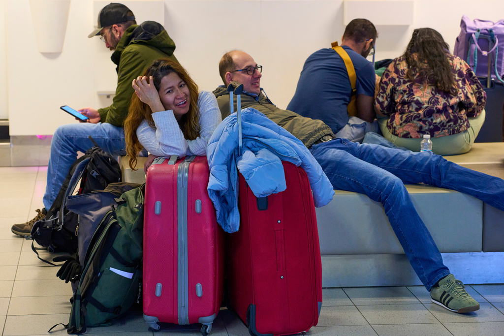 Stranded travellers wait at Schiphol airport in Amsterdam, Netherlands, Wednesday, Jan. 7, 2026, where more than 1,000 stranded passengers spent the night as snow and ice that is pummeling parts of Europe grounded hundreds of flights and choked highways and railroads. (AP Photo/Peter Dejong)