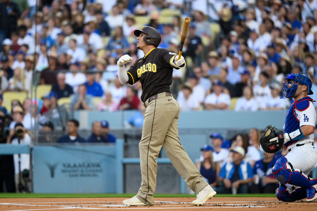 San Diego Padres' Manny Machado hits a two-run home run during the first inning of a baseball game against the Los Angeles Dodgers in Los Angeles, Thursday, July 2, 2026. (AP Photo/Kyusung Gong)