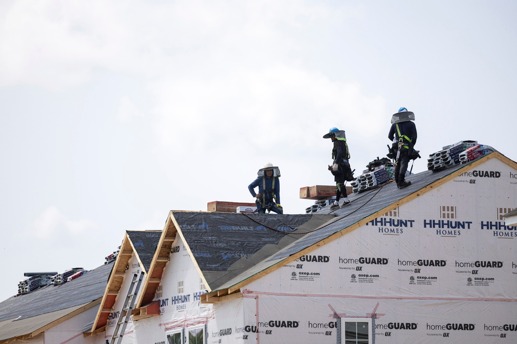 FILE - People work on the roof of a new housing development in Sandston, Va., June 6, 2025. (Mike KRopf/Richmond Times-Dispatch via AP, File)