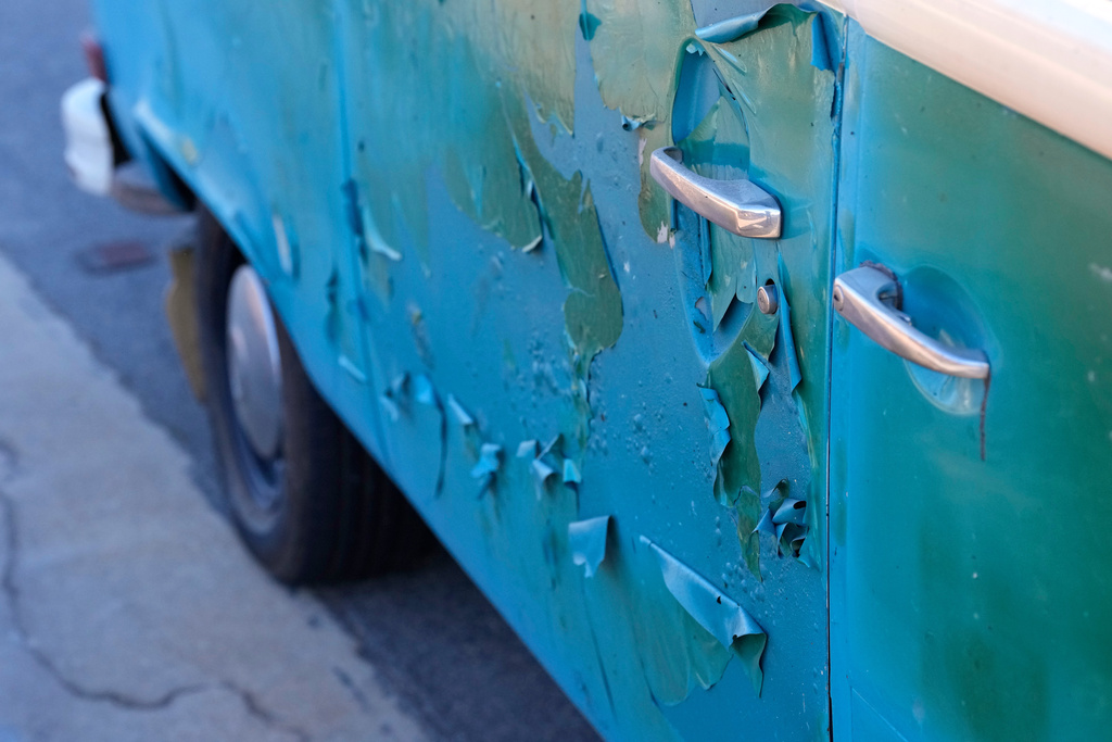 FILE - The Volkswagen bus, named Azul by its owner, sits with some damage in front of burned out homes, Wednesday, Jan. 15, 2025, in Malibu, Calif. (AP Photo/Mark J. Terrill, File)