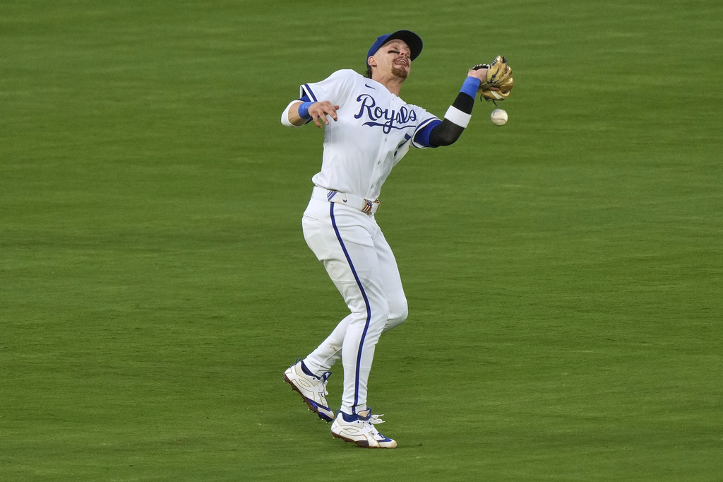 Kansas City Royals shortstop Bobby Witt Jr. can't catch a force out hit into by Washington Nationals' Paul DeJong to score one run during the sixth inning of a baseball game Tuesday, Aug. 12, 2025, in Kansas City, Mo. (AP Photo/Charlie Riedel)