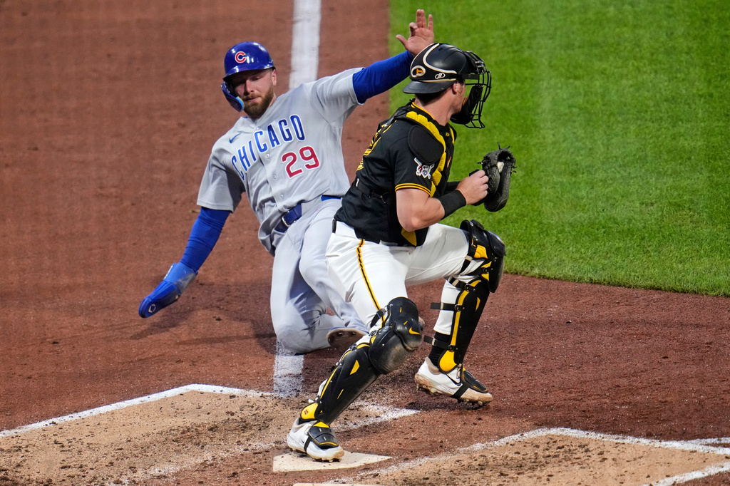 Pittsburgh Pirates catcher Henry Davis, right, gets the force out at home plate on Chicago Cubs' Michael Busch (29) who was forced from third on a fielder's choice by Cubs' Moisés Ballesteros during the sixth inning of a baseball game in Pittsburgh, Tuesday, May 26, 2026. (AP Photo/Gene J. Puskar)