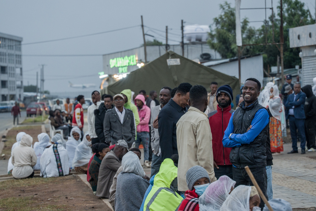 People gather outside a polling station before casting their votes in the general election in Addis Ababa, Ethiopia, Monday, June 1, 2026. (AP Photo/Amanuel Sileshi)