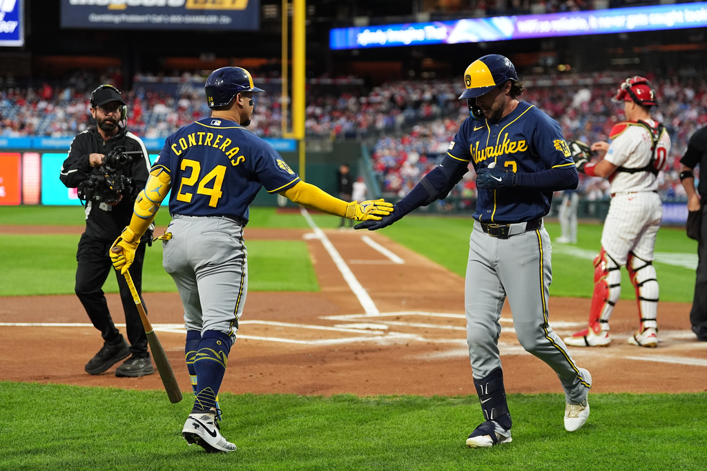 Milwaukee Brewers' Brice Turang, right, celebrates hits a home run off of Philadelphia Phillies pitcher Aaron Nola with teammate William Contreras during the first inning of a baseball game, Wednesday, Sept. 23, 2026, in Philadelphia. (AP Photo/Matt Rourke)