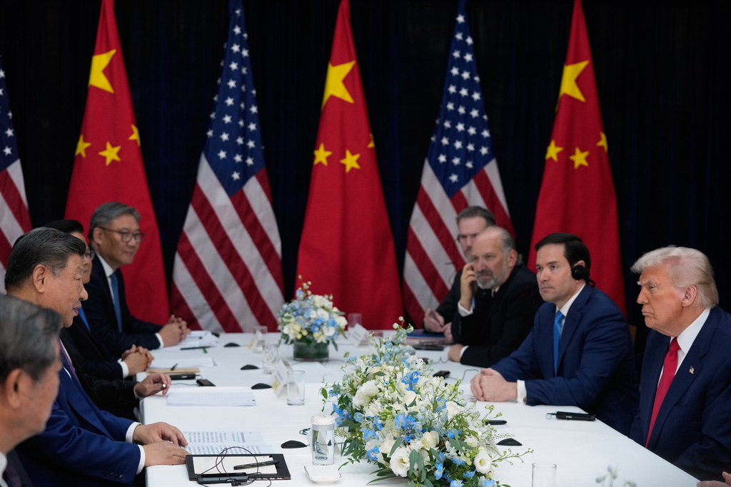 President Donald Trump, right, and Chinese President Xi Jinping, second left, hold their summit talk at Gimhae International Airport in Busan, South Korea, Thursday, Oct. 30, 2025. (AP Photo/Mark Schiefelbein)