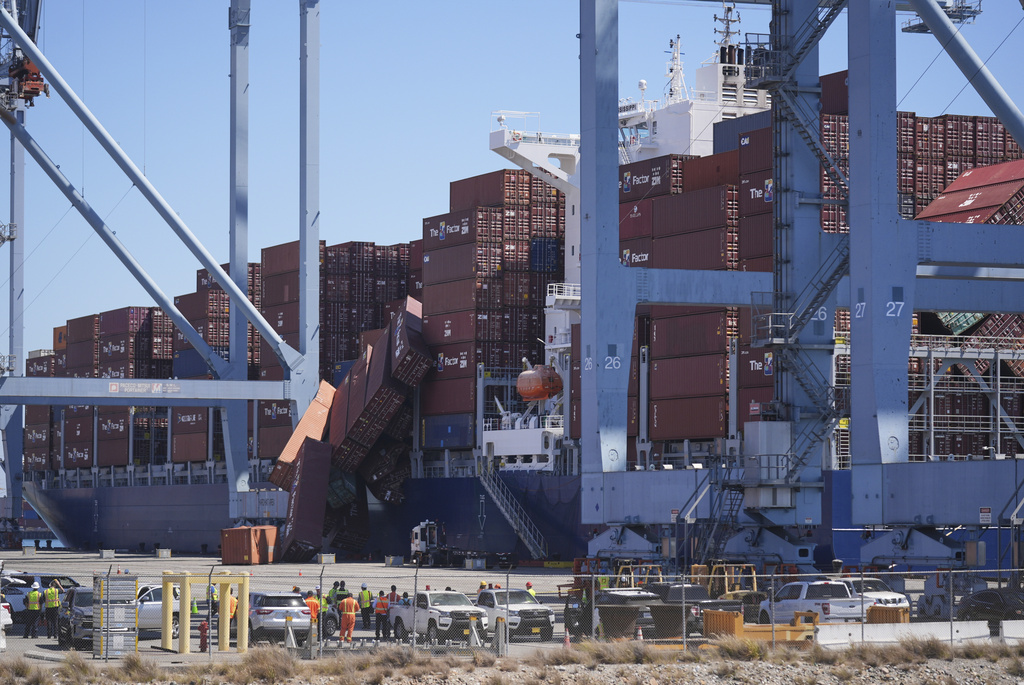 Containers topple off a cargo ship at the Port of Long Beach on Tuesday, Sept. 9, 2025, in Long Beach, Calif. (AP Photo/Damian Dovarganes)