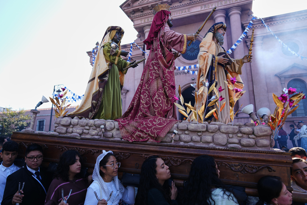 Catholics carry a religious float transporting statues representing the Three Wise Men: Balthazar, Gaspar and Melchior, during a procession marking Three Kings Days, also known as feast day of The Epiphany, at the Guardia Viejo neighborhood in Guatemala City, Tuesday, Jan. 6, 2026. (AP Photo/Moises Castillo)