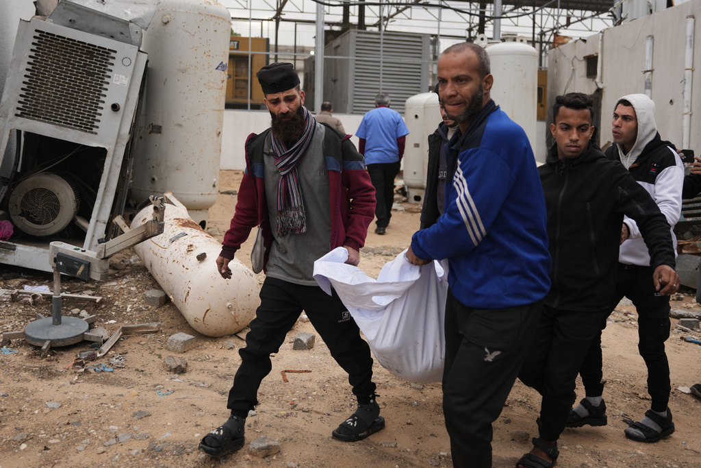 The bodies of Amal Abu Al-Khair and her grandchild, Saud, are transferred to Al-Shifa Hospital in Gaza City after they were killed when their tent caught fire overnight at the Yarmouk displacement camp, Friday, Jan. 2, 2026. (AP Photo/Jehad Alshrafi)