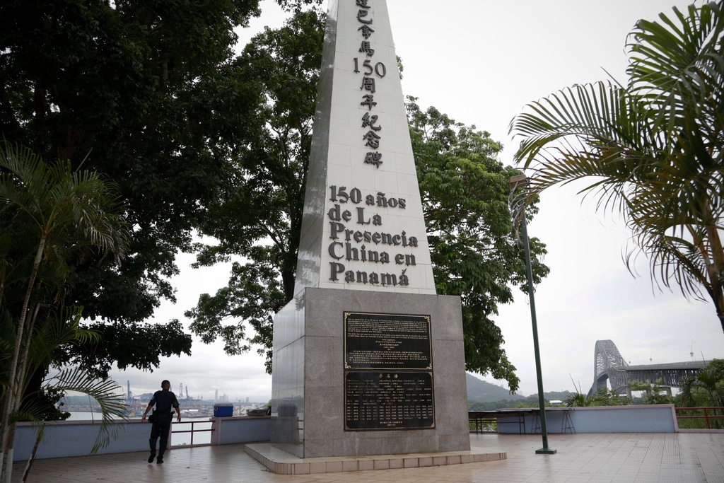 FILE - A police officer walks by a monument honoring 150 years of the Chinese community in Panama City, June 13, 2017. (AP Photo/Arnulfo Franco, File)