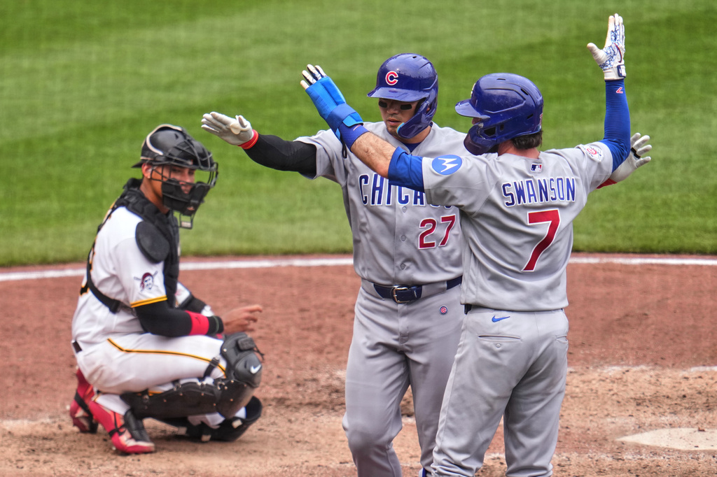 Chicago Cubs' Seiya Suzuki (27) is greeted by Dansby Swanson (7) after hitting a two-run home run off Pittsburgh Pirates pitcher Mason Montgomery as Pirates catcher Shawn Ross, left, looks on during the ninth inning of a baseball game in Pittsburgh, Sunday, July 26, 2026. (AP Photo/Gene J. Puskar)