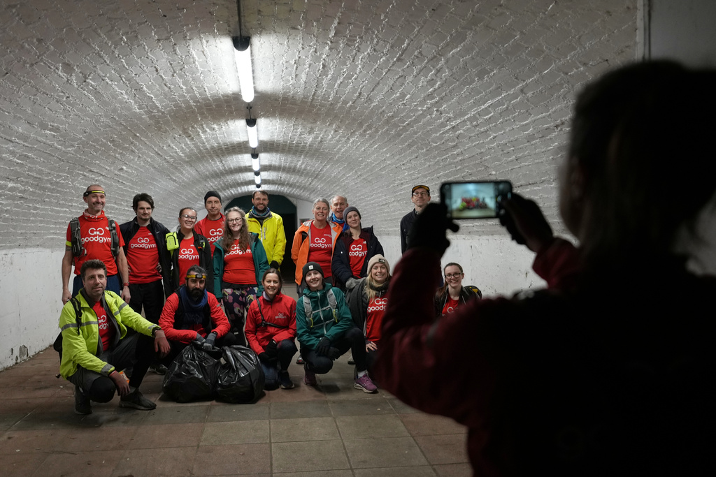Participants in the Goodgym group pose for a group photograph after collecting litter to keep the River Thames free of plastic and other waste in London, Wednesday, Jan. 14, 2026. (AP Photo/Kirsty Wigglesworth)