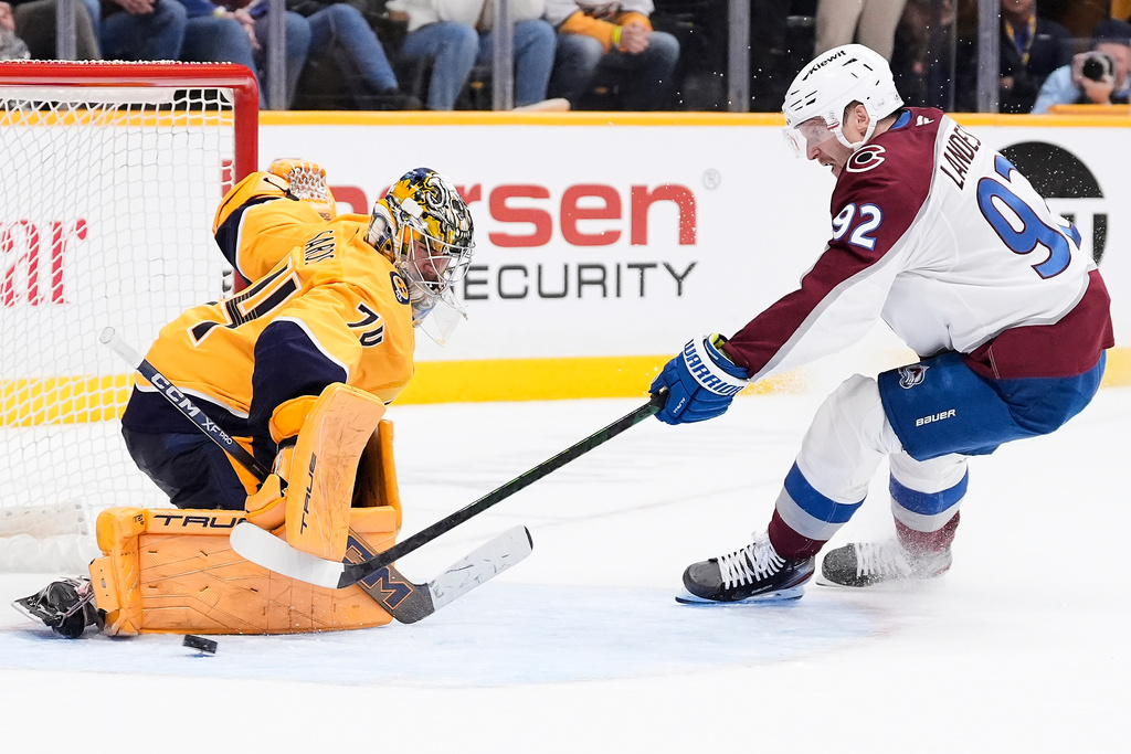 Nashville Predators goaltender Juuse Saros (74) blocks a penalty shot by Colorado Avalanche left wing Gabriel Landeskog (92) during overtime of an NHL hockey game Tuesday, Dec. 9, 2025, in Nashville, Tenn. (AP Photo/George Walker IV)