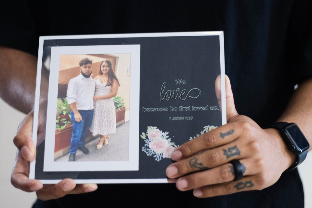 FILE - Army Sgt. Hedar Leonel Turcios Juarez holds a picture of himself with with his wife Cristy at home in El Paso, Texas, July 21, 2026. (AP Photo/Ryan Romero, File)