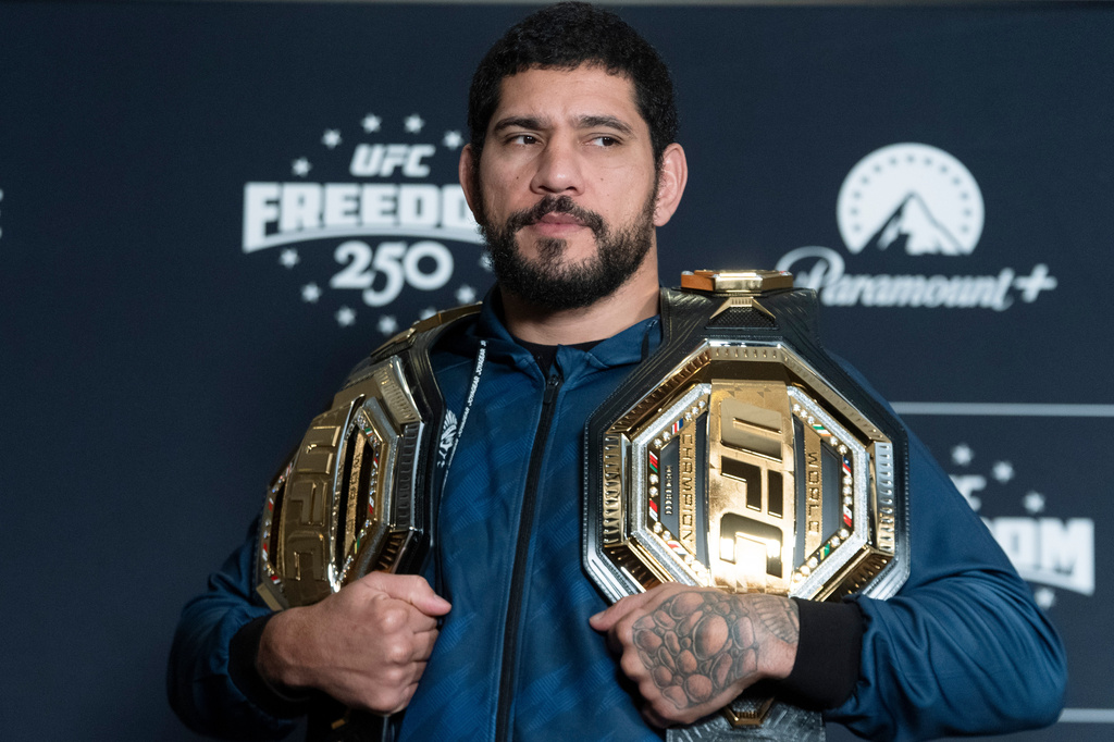 Former UFC light heavyweight champion Alex Pereira from Brazil, holds his championship belts during the UFC Freedom 250 media day, Wednesday, June 10, 2026, in Washington. (AP Photo/Manuel Balce Ceneta)