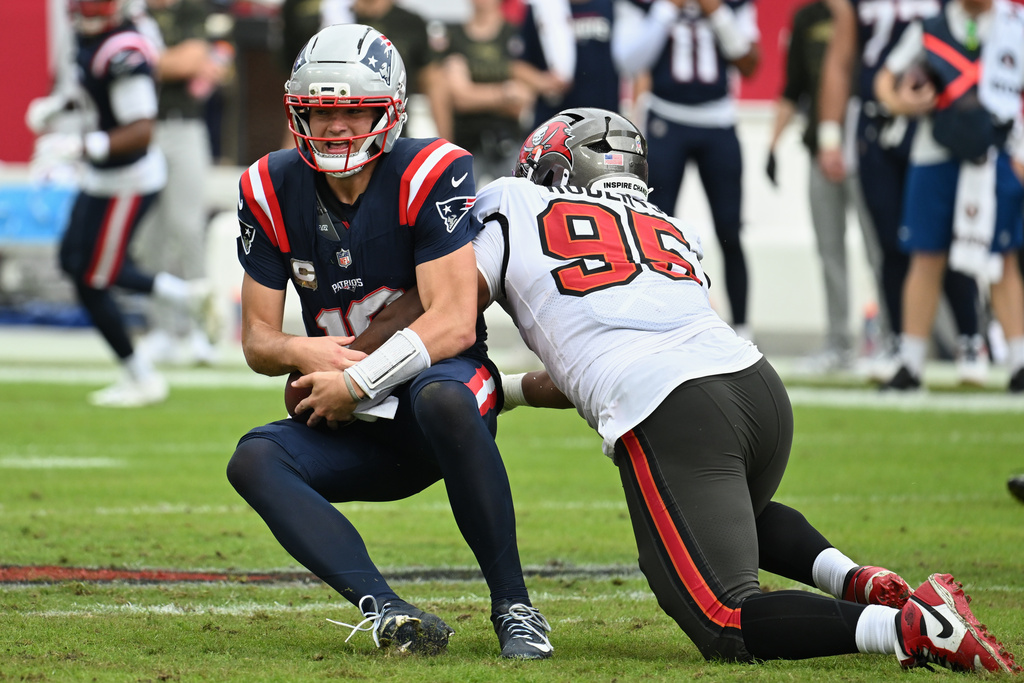 Tampa Bay Buccaneers defensive end Elijah Roberts (95) sacks New England Patriots quarterback Drake Maye (10) during the first half of an NFL football game Sunday, Nov. 9, 2025, in Tampa, Fla. (AP Photo/Jason Behnken)