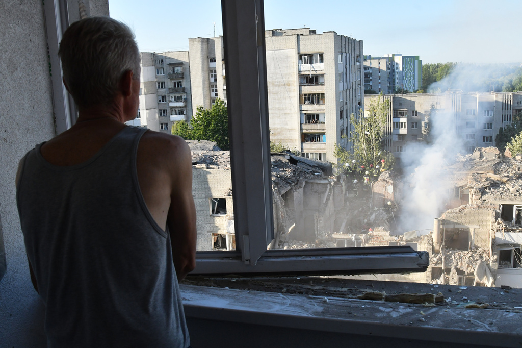 A man watches as rescuers clear the rubble at the damaged apartment building in a residential neighbourhood following a Russian air attack in Lviv, Ukraine, Thursday, July 30, 2026. (AP Photo/Mykola Tys)