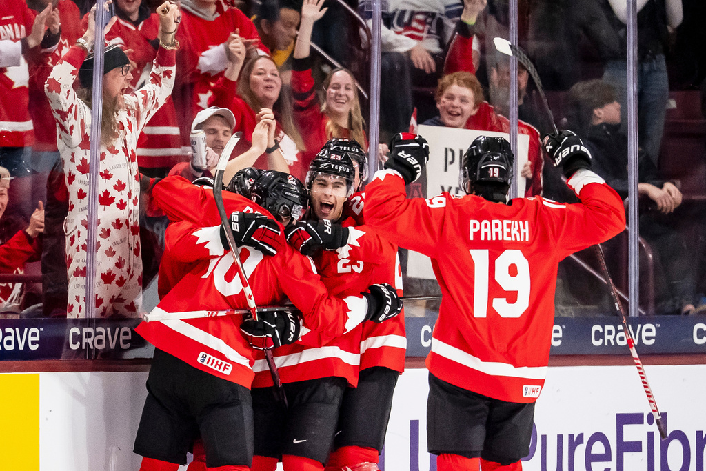 Canada's Cole Beaudoin (26) celebrates his goal with teammates after scoring in second period IIHF World Junior Championship hockey action against Finland in Minneapolis on Wednesday, Dec. 31, 2025. (Christopher Katsarov/The Canadian Press via AP)