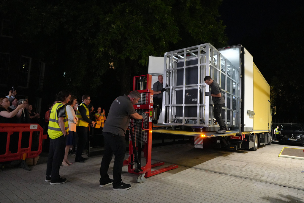 Workers unload a box that contains the Bayeux Tapestry from a truck at the British Museum in London, Friday, July 10, 2026. (AP Photo/Kwiyeon Ha)