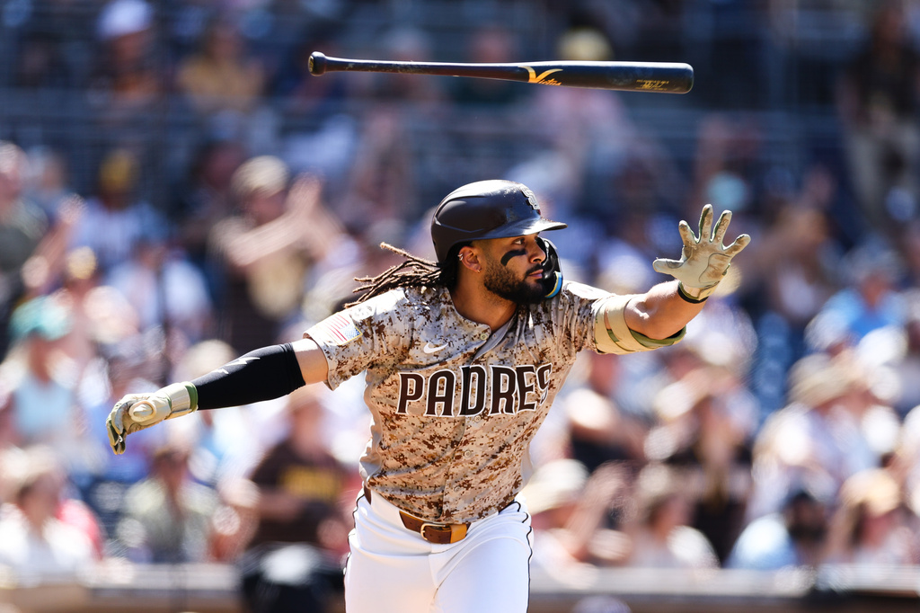 San Diego Padres' Fernando Tatis Jr. tosses his bat after hitting a two-RBI single against the Minnesota Twins in the sixth inning of a baseball game Sunday, Aug. 23, 2026, in San Diego. (AP Photo/Derrick Tuskan)