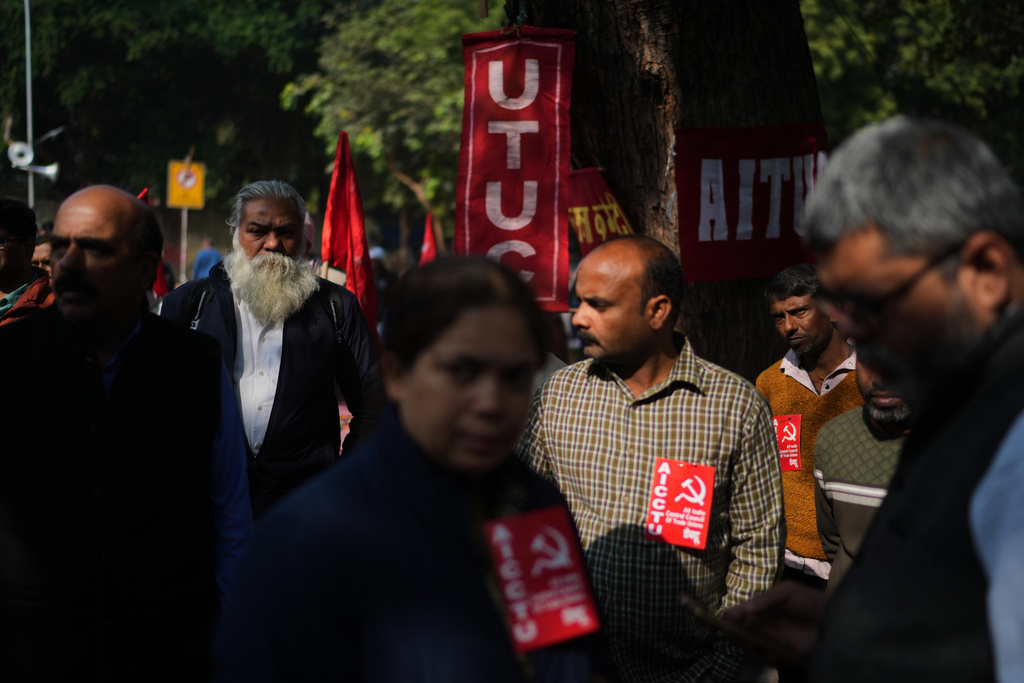 Members of various Indian trade unions listen to a speech of their leader during a protest against the government's rollout of new labor codes in New Delhi, India, Wednesday, Nov. 26, 2025. (AP Photo/Manish Swarup)