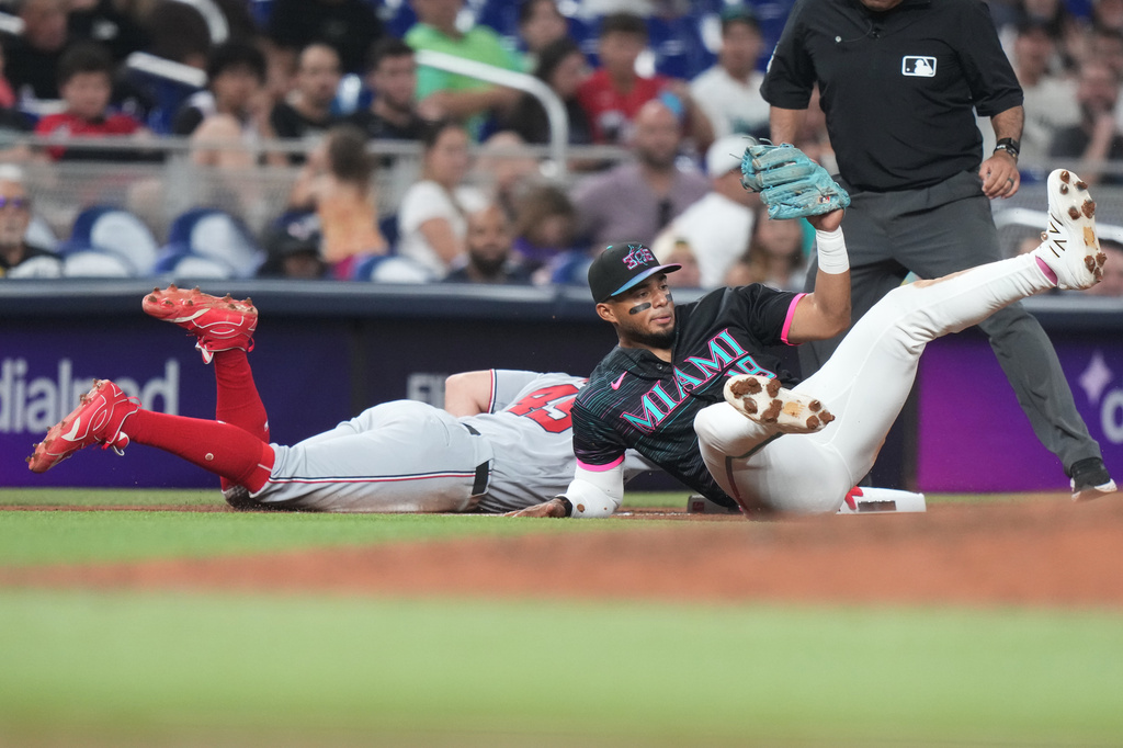Washington Nationals' Curtis Mead (45) beats the throw to Miami Marlins third baseman Leo Jimenez, right, during the fifth inning of a baseball game, Friday, May 8, 2026, in Miami. (AP Photo/Lynne Sladky)