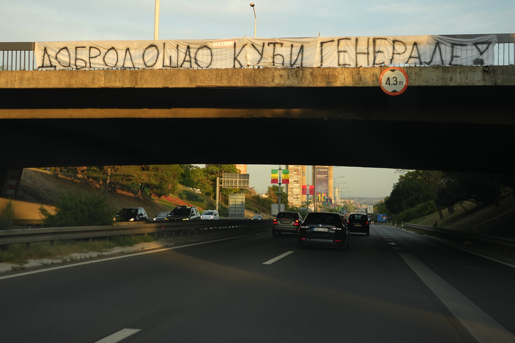 Cars move along under a bridge with a banner on it reading: "Welcome home, General! (former Bosnian Serb wartime general Ratko Mladic)" in Belgrade, Serbia, Thursday, Sept. 3, 2026. (AP Photo/Darko Vojinovic)