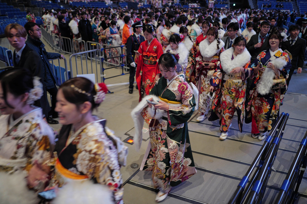 Young adults leave a venue after marking the Coming-of-Age Day, a centuries-old tradition and national holiday marking the milestone from childhood to adulthood, Monday, Jan. 12, 2026, in Yokohama near Tokyo. (AP Photo/Eugene Hoshiko)