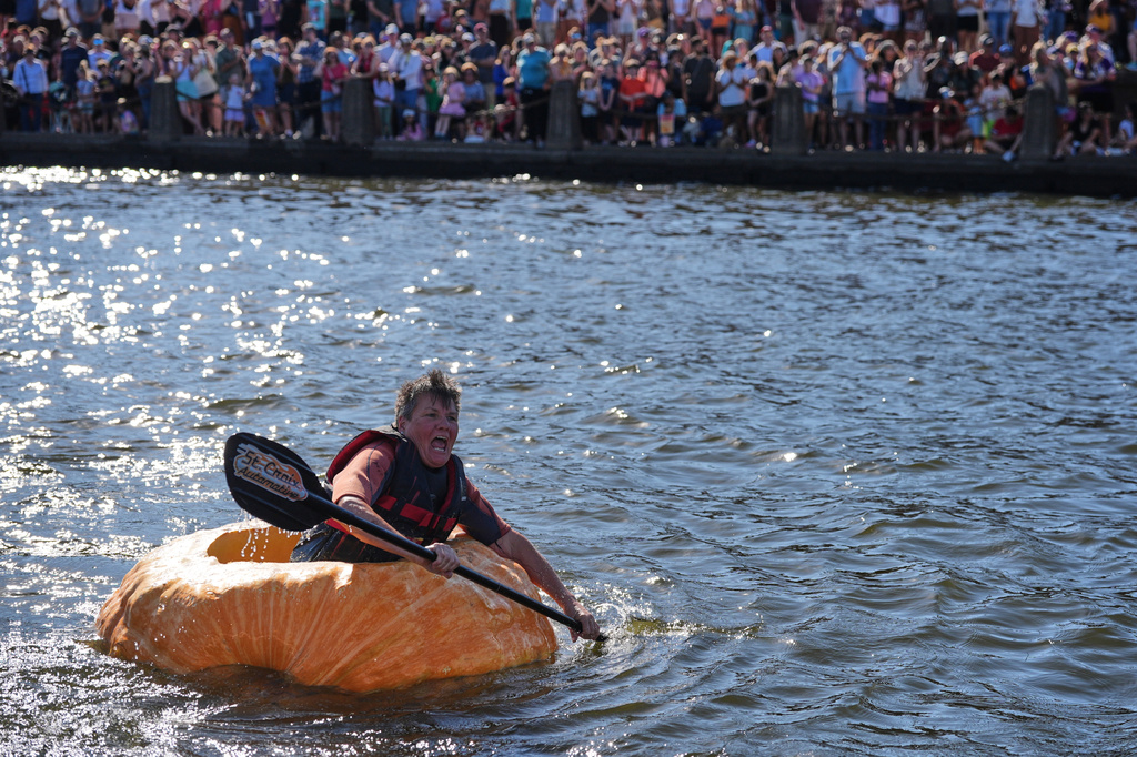 Laura Fairchild paddles a giant pumpkin to the finish line in the pumpkin regatta race during the annual Harvest Festival, Sunday, Oct. 11, 2026, in Stillwater, Minn. (AP Photo/Ellen Schmidt)