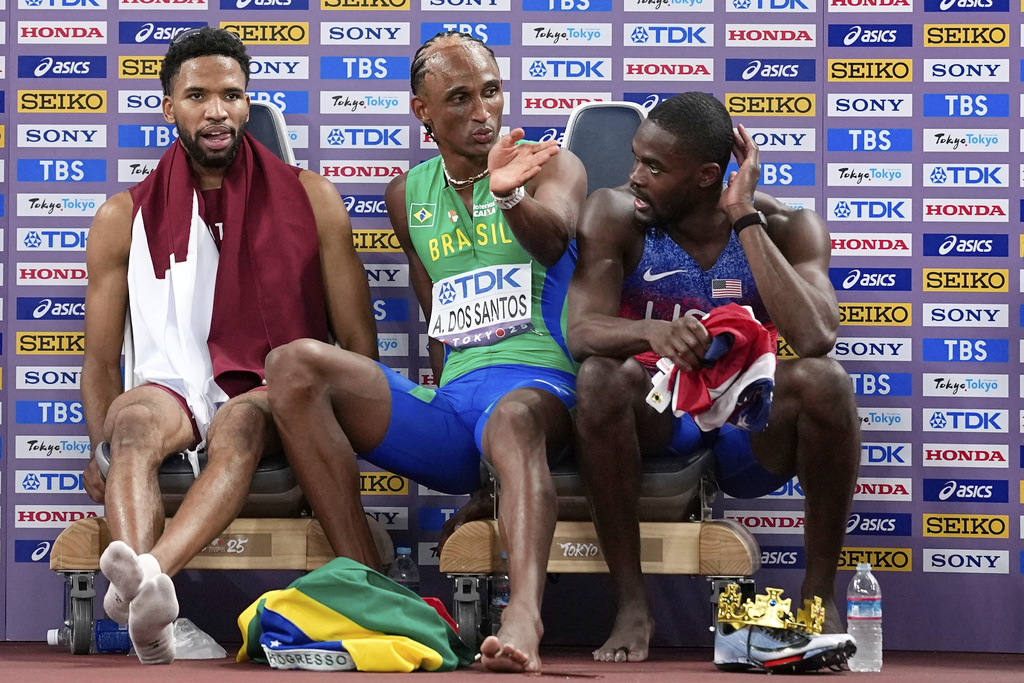 Gold medalist United States' Rai Benjamin, silver medalist Brazil's Alison Dos Santos and bronze medalist Qatar's Abderrahman Samba, from right, sit together after the men's 400 meters hurdles final at the World Athletics Championships in Tokyo, Friday, Sept. 19, 2025. (AP Photo/Matthias Schrader)