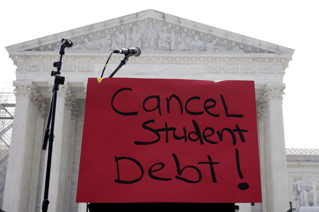 FILE - A sign reading &quot;cancel student debt&quot; is seen outside the Supreme Court, June 30, 2023, in Washington. (AP Photo/Mariam Zuhaib, File)