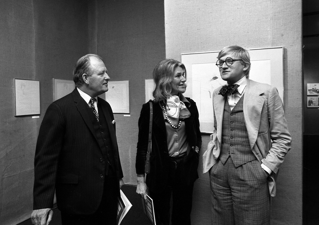 FILE - Painter David Hockney, right, with British Ambassador Edward Tomkins, left, at the opening of his exhibition at Musee des Arts Decoratifs on Oct. 10, 1974 in Paris. (AP Photo/Michel Lipchitz, File)