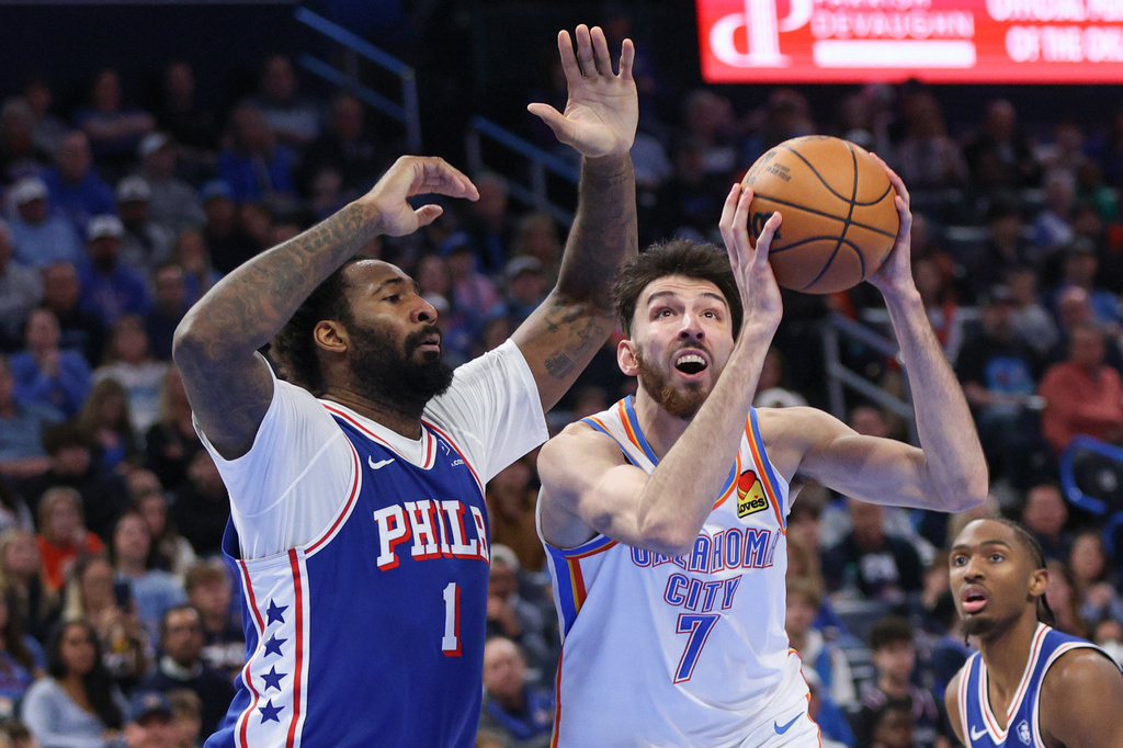 Oklahoma City Thunder center Chet Holmgren (7) goes to the basket against Philadelphia 76ers center Andre Drummond (1) during the second half of an NBA basketball game Sunday, Dec. 28, 2025, in Oklahoma City. (AP Photo/Nate Billings)