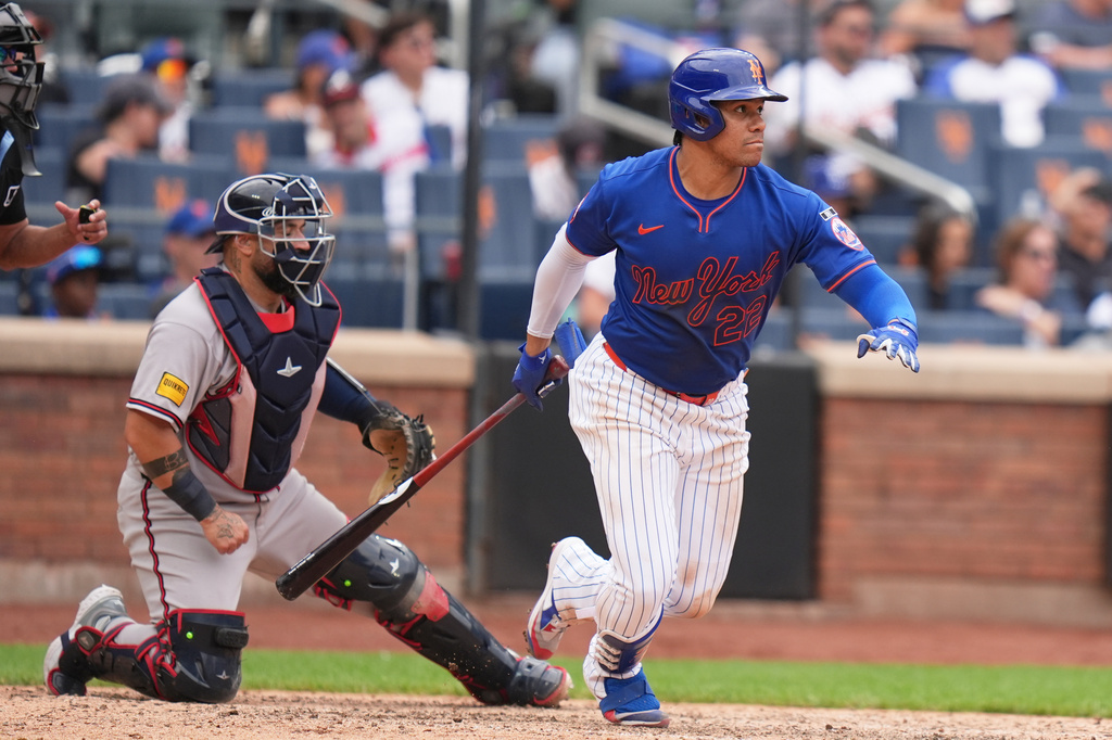 New York Mets' Juan Soto looks after his two-run single during the eighth inning of a baseball game against the Atlanta Braves, Sunday, June 14, 2026, in New York. (AP Photo/Seth Wenig)