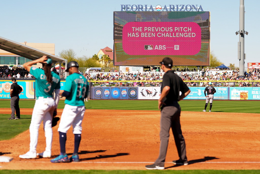 FILE - An outfield screen shows a graphic indicating Seattle Mariners' Julio Rodriguez challenged a pitch call, initiating a review with the automated ball-strike challenge system, in the third inning against the Arizona Diamondbacks during a spring training baseball game Sunday, Feb. 23, 2025, in Peoria, Ariz. (AP Photo/Lindsey Wasson, file)