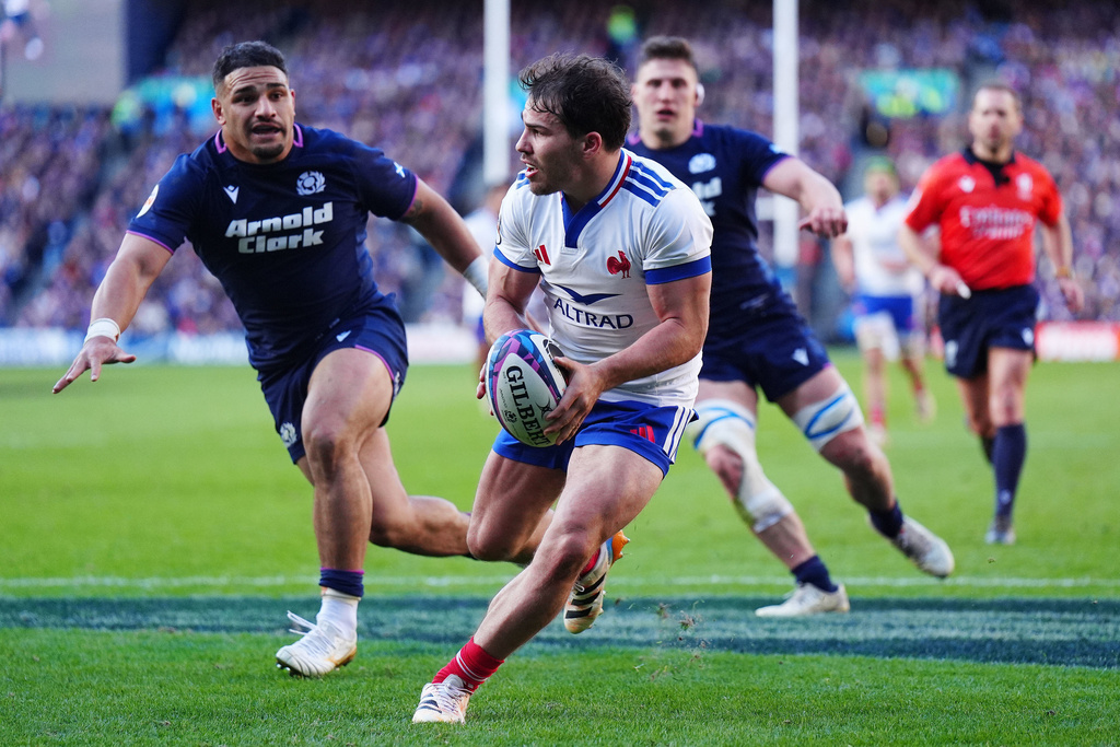 France's Antoine Dupont and Scotland's Sione Tuipulotu, left, in action during the Six Nations rugby match between Scotland and France in Edinburgh, Scotland, Saturday March 7, 2026. (Jane Barlow/PA via AP)