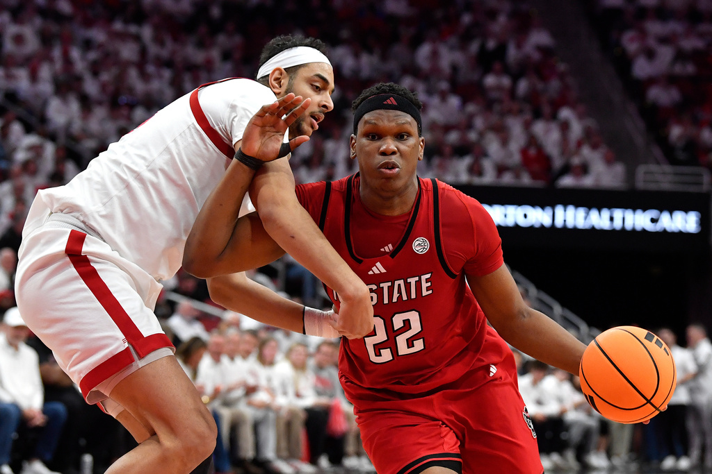 North Carolina State forward Ven-Allen Lubin (22) drives against Louisville center Aly Khalifa, left, during the first half of an NCAA college basketball game in Louisville, Ky., Monday, Feb. 9, 2026. (AP Photo/Timothy D. Easley)