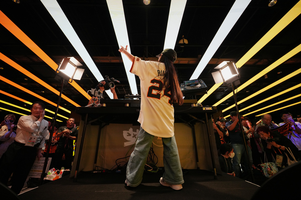 Nine-year-old DJ Rinoka performs at Tokyo Dome before a Yomiuri Giants baseball game on May 24, 2026, in Tokyo. (AP Photo/Eugene Hoshiko)