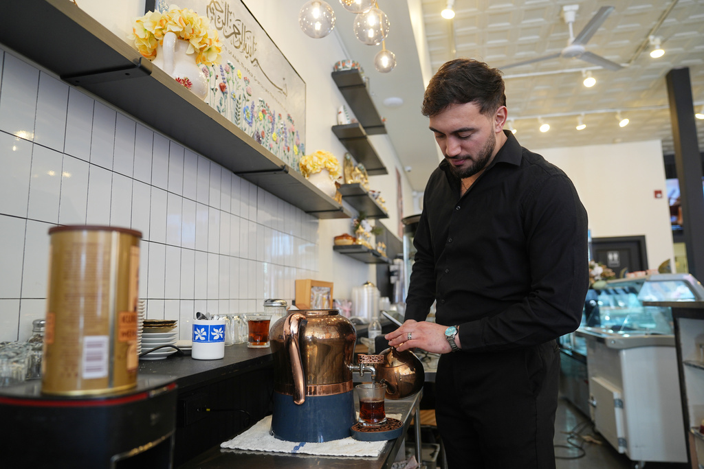 Muhammed Emanet pours Turkish tea for a guest at the Jersey Kebab restaurant, Thursday, Jan. 29, 2026, in Collingswood, N.J. (AP Photo/Matt Rourke)