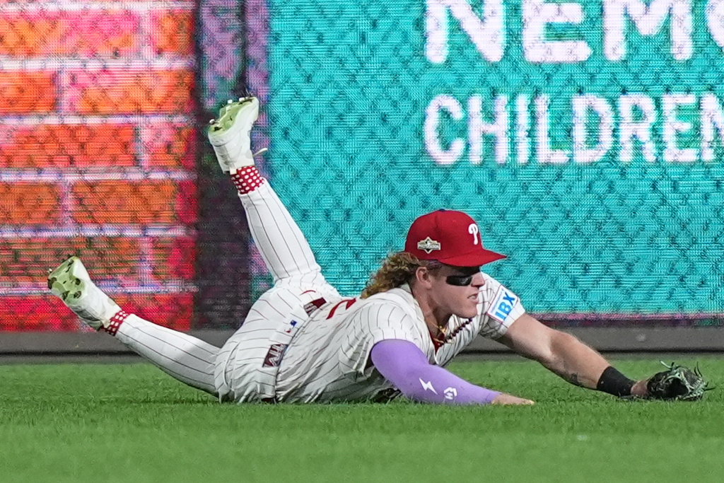 Philadelphia Phillies center fielder Harrison Bader catches a pop-foul out by Los Angeles Dodgers' Andy Pages during the fifth inning in Game 1 of baseball's National League Division Series, Saturday, Oct. 4, 2025, in Philadelphia. (AP Photo/Matt Rourke)