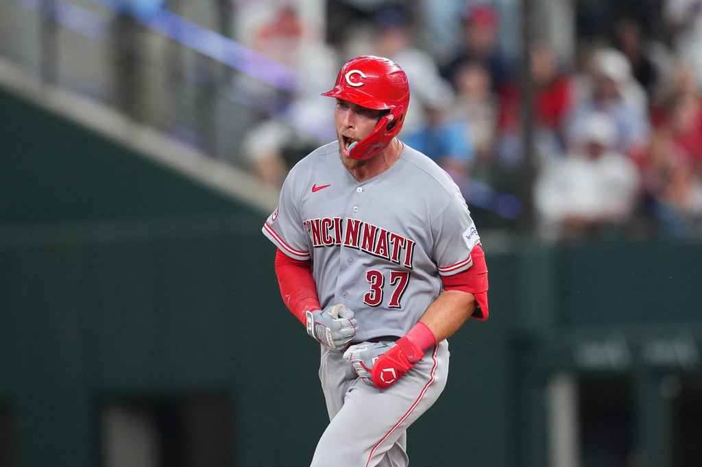 Cincinnati Reds' Tyler Stephenson reacts after hitting a two-run home run off Texas Rangers pitcher Chris Martin during the ninth inning of the Rangers' home-opener baseball game Friday, April 3, 2026, in Arlington, Texas. (AP Photo/Julio Cortez)